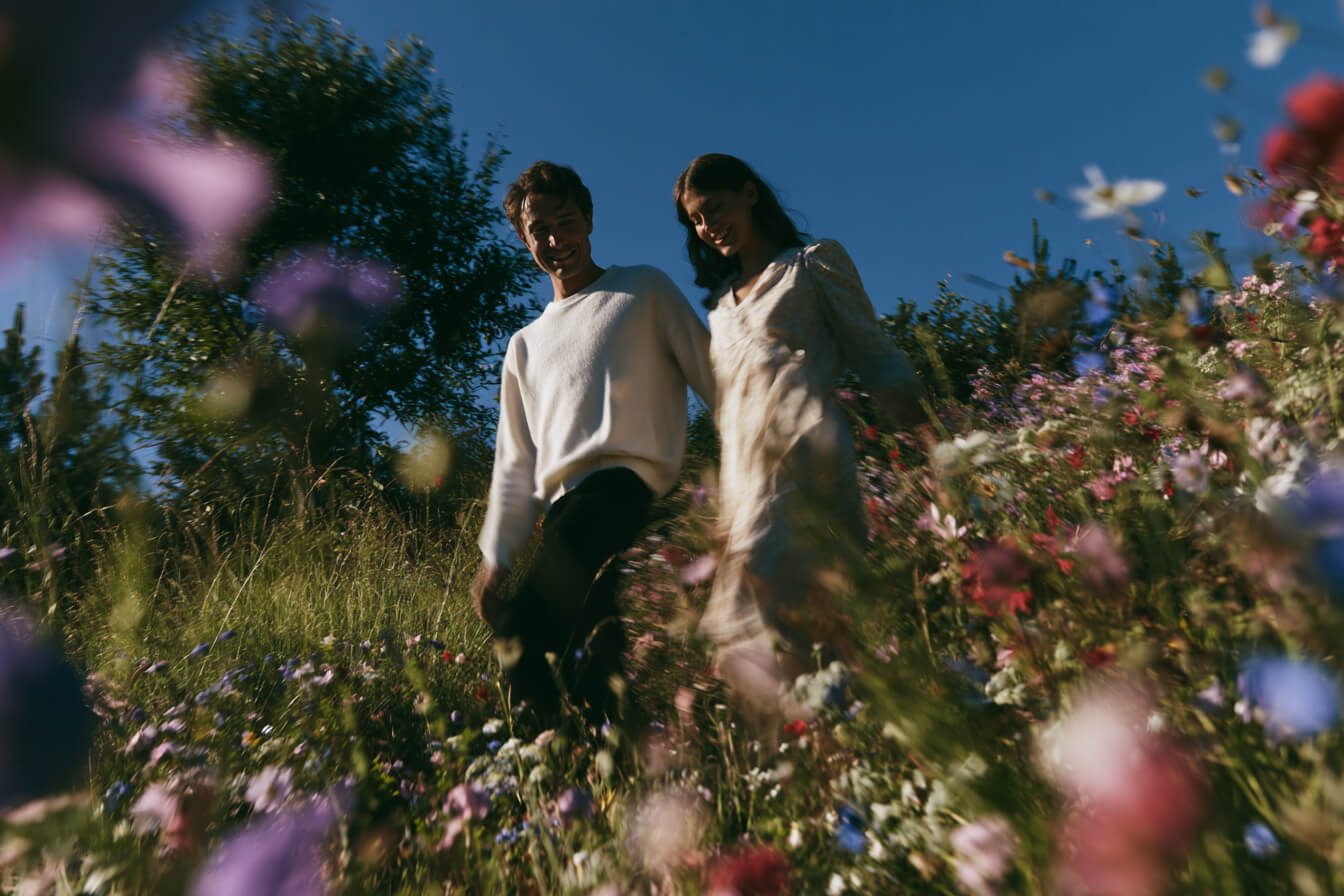 Klyyr hydroxyapatite toothpaste — Two active people walking through an open meadow