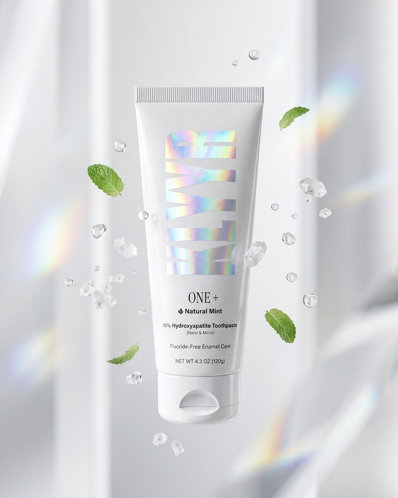 Klyyr One+ natural mint hydroxyapatite toothpaste tube floating with mint leaves and mineral crystals